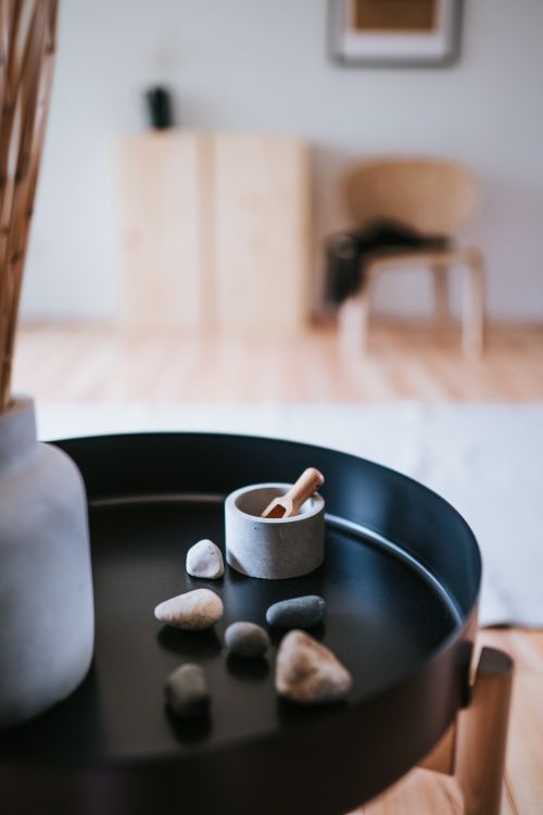 Free Elegant Japandi-style round table with pebbles and decor for modern interior design. Stock Photo