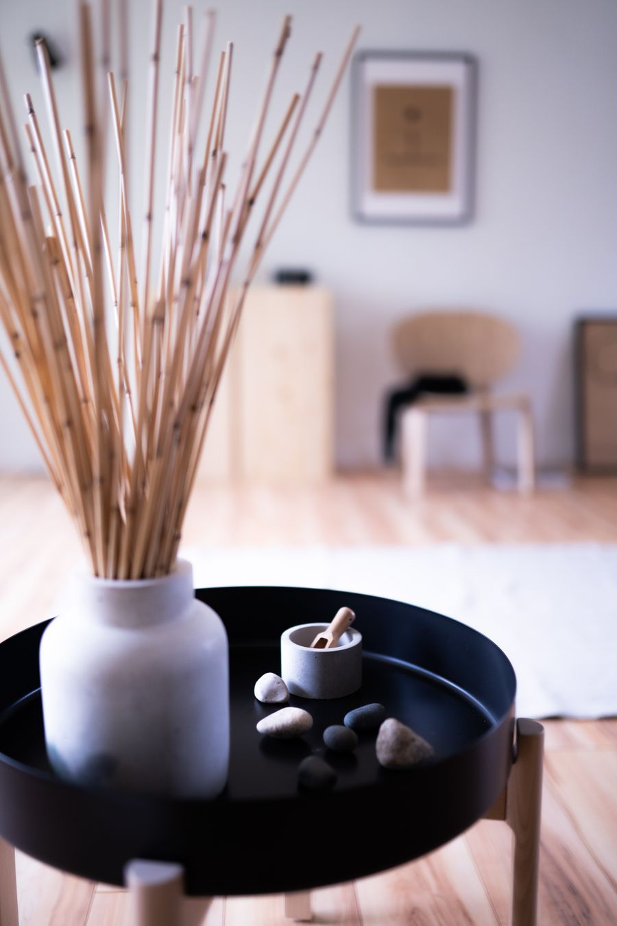 Round timber table with bamboo styling in a softly lit room