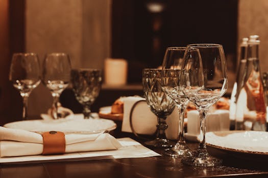 Sophisticated dinner table arrangement with glassware and candlelight for a fine dining experience.