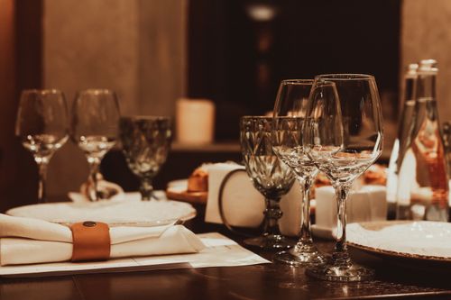 Free Sophisticated dinner table arrangement with glassware and candlelight for a fine dining experience. Stock Photo