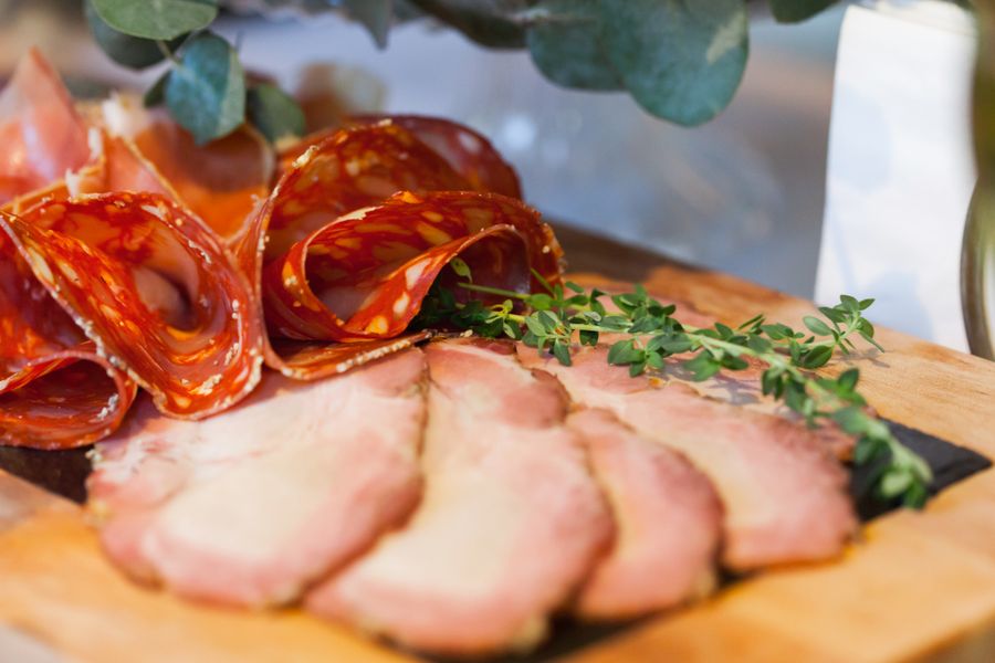 Cured meats and herbs on a board
