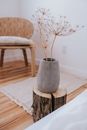 Gray Pot with Flowers on Chopped Wooden Log