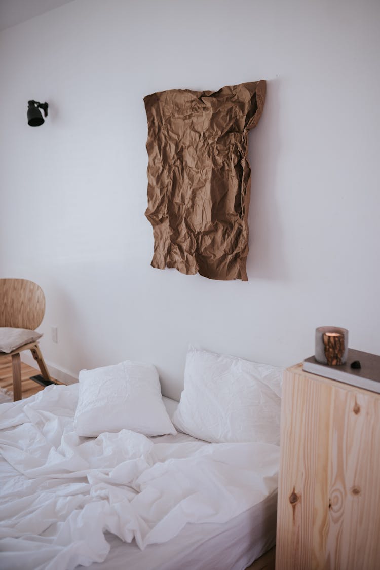 Japandi Style Bedroom With White Bed Linen And Brown Creased Picture