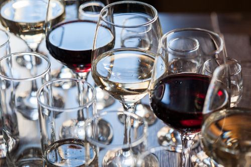 Free A variety of red and white wines elegantly displayed in glasses, capturing their rich colors and textures. Stock Photo