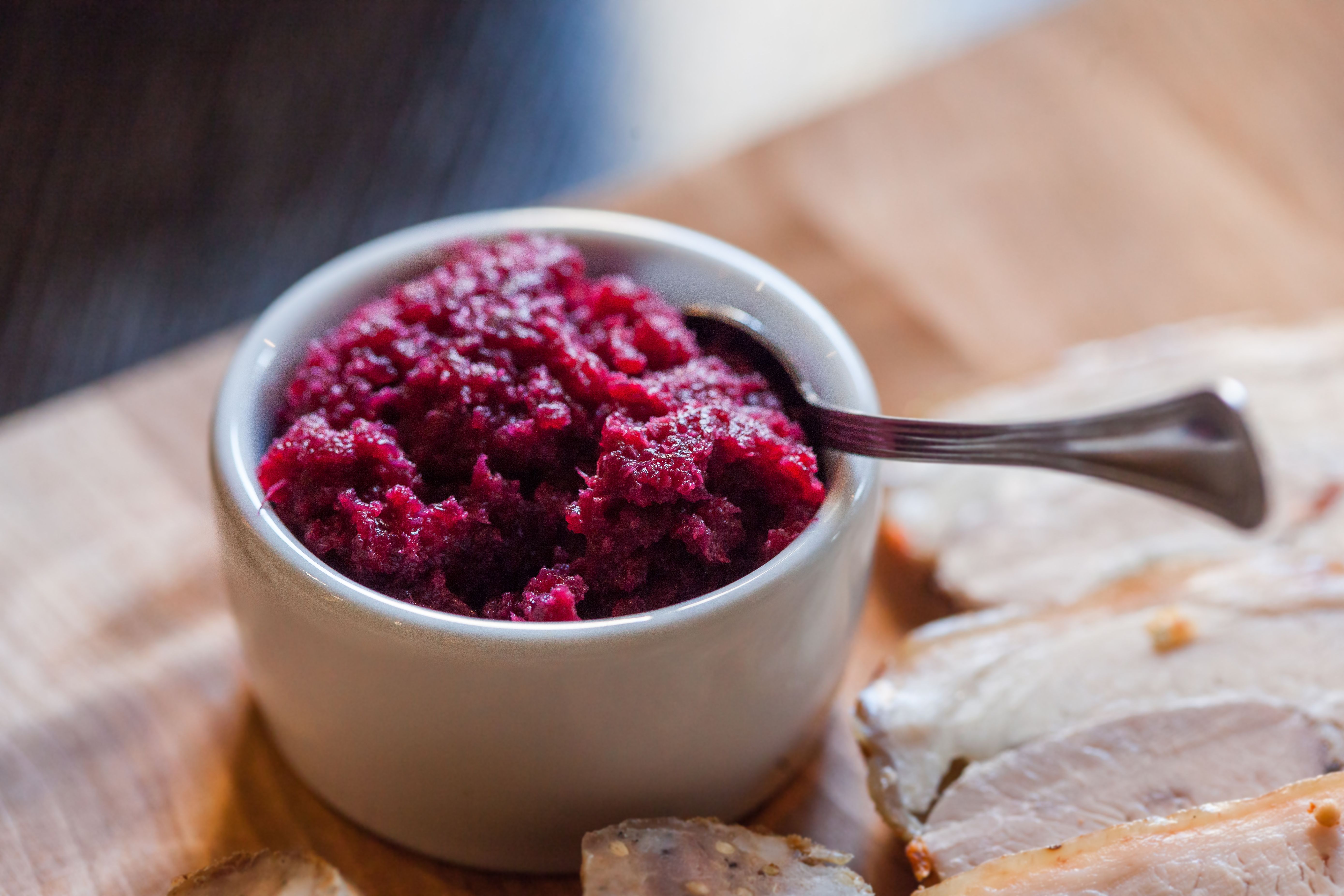 Glass bowl filled with bright red cranberry relish