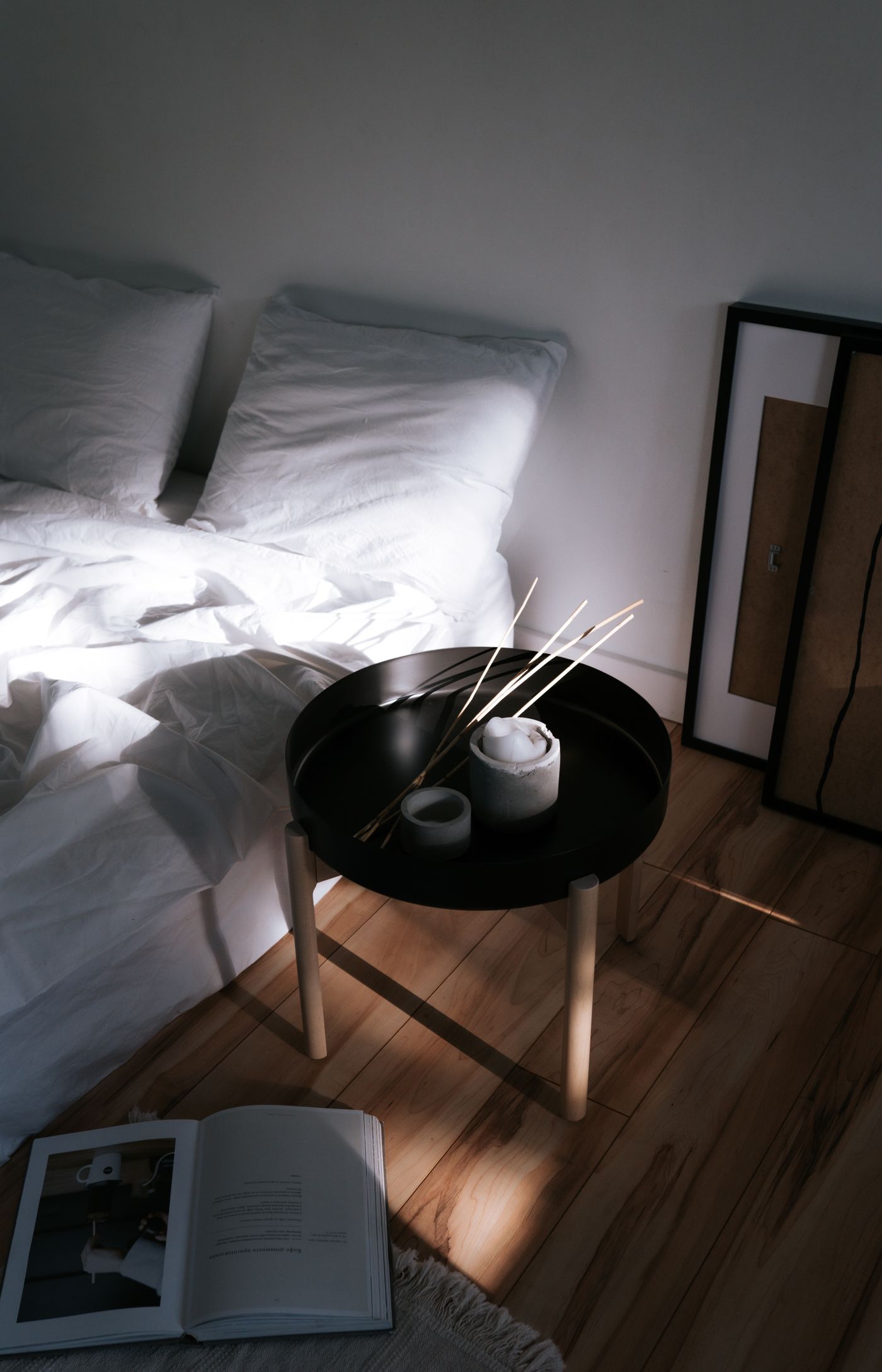 Calm Japandi bedroom in soft daylight with a low bed and timber side table