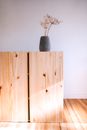 A Gray Vase on the Top of a Wooden Cabinet