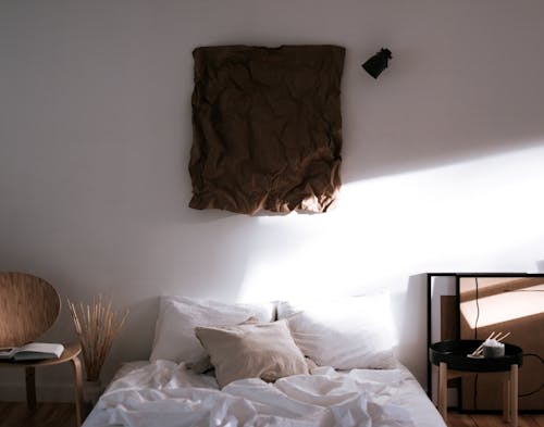 Brown Textile on White Bed
