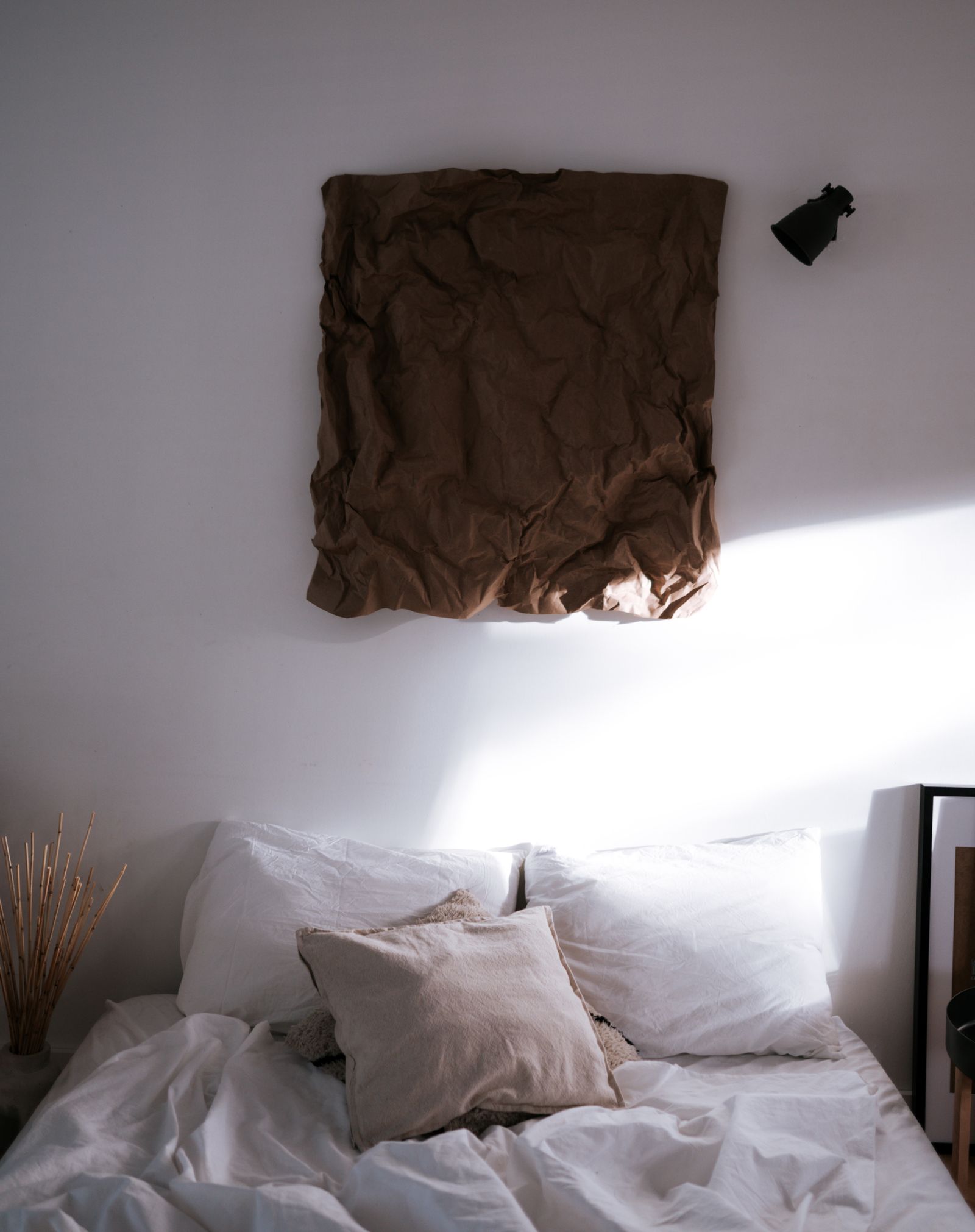 Sunlit white bedding and pillows in a peaceful home setting