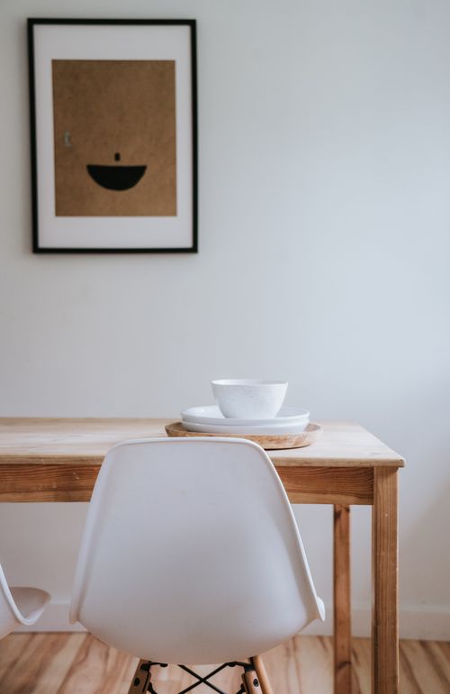 Free Minimalist Japandi style dining area with ceramics and framed art piece. Stock Photo