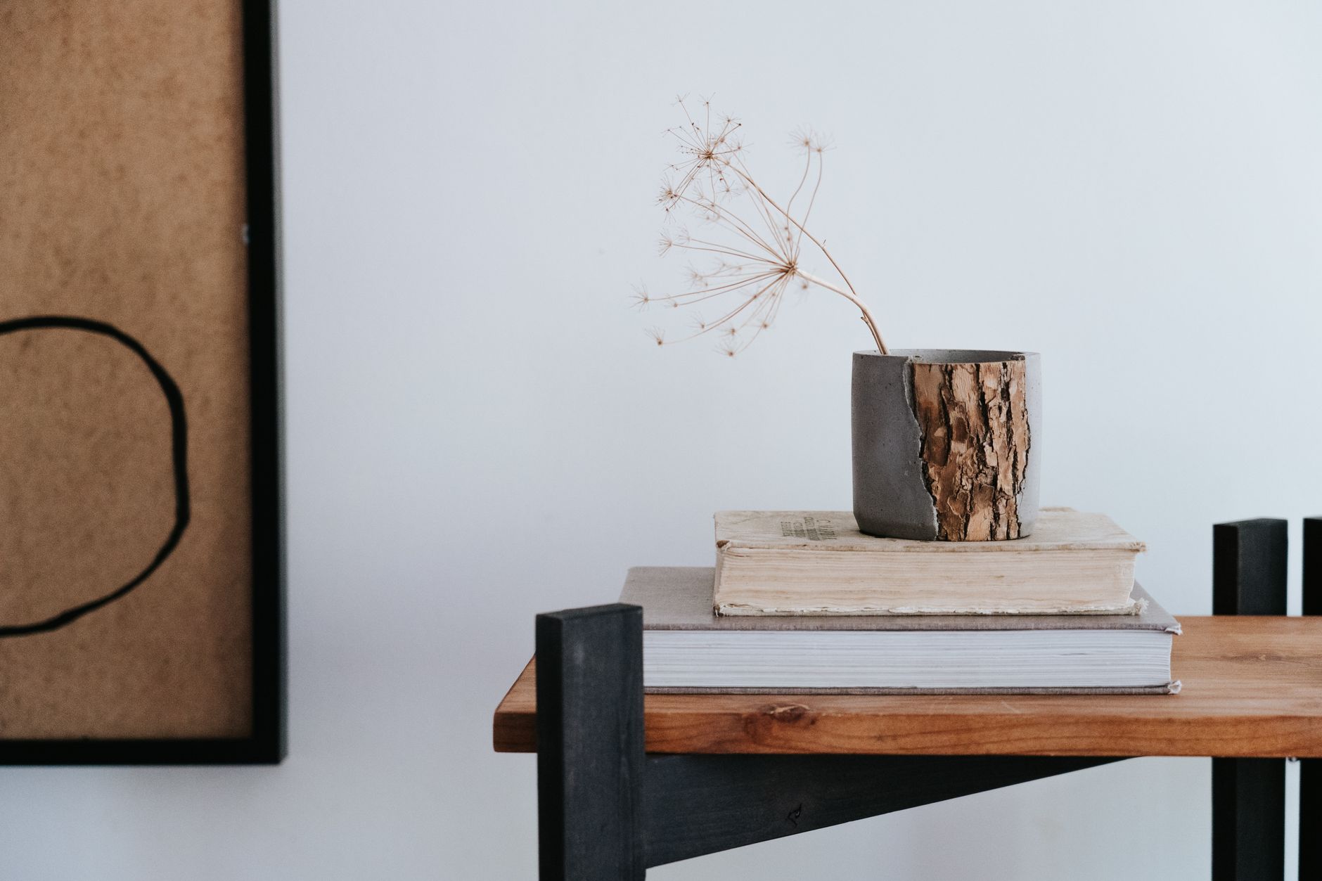 Aesthetic minimalist still life with books, dried flower, and modern home decor.