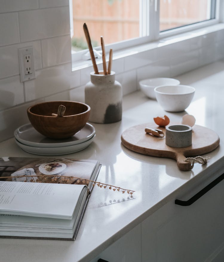 Round Wooden Chopping Board On White Kitchen Countertop 