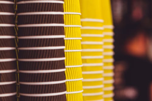 Yellow and Brown Cups in Close Up Photography