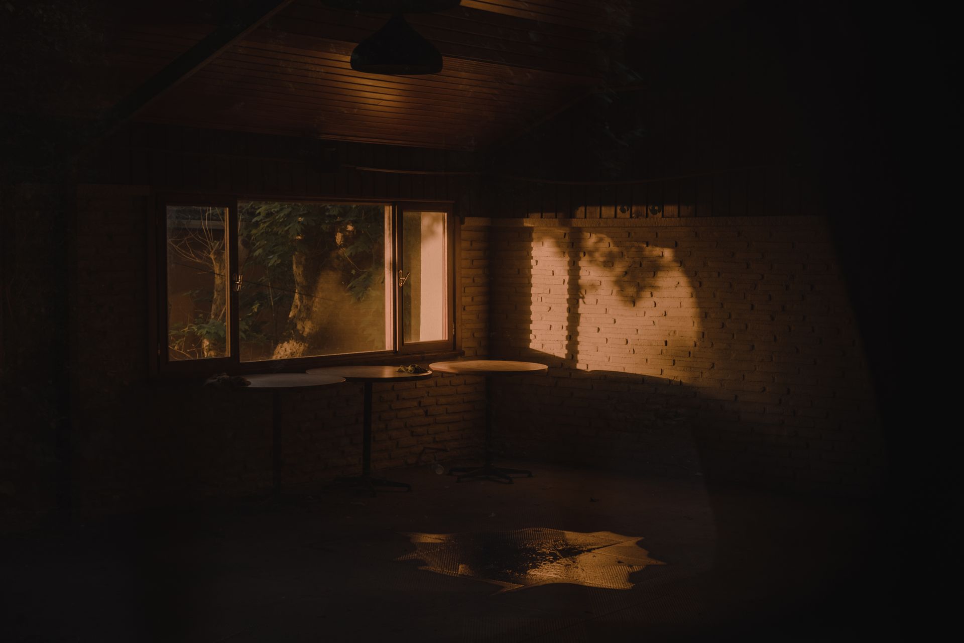 A single empty glass on a dimly lit table