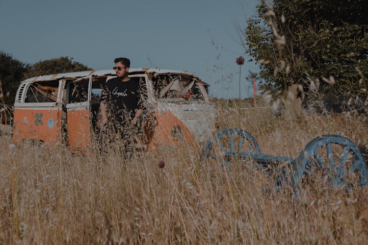 A Man Looking Around The Junkyard