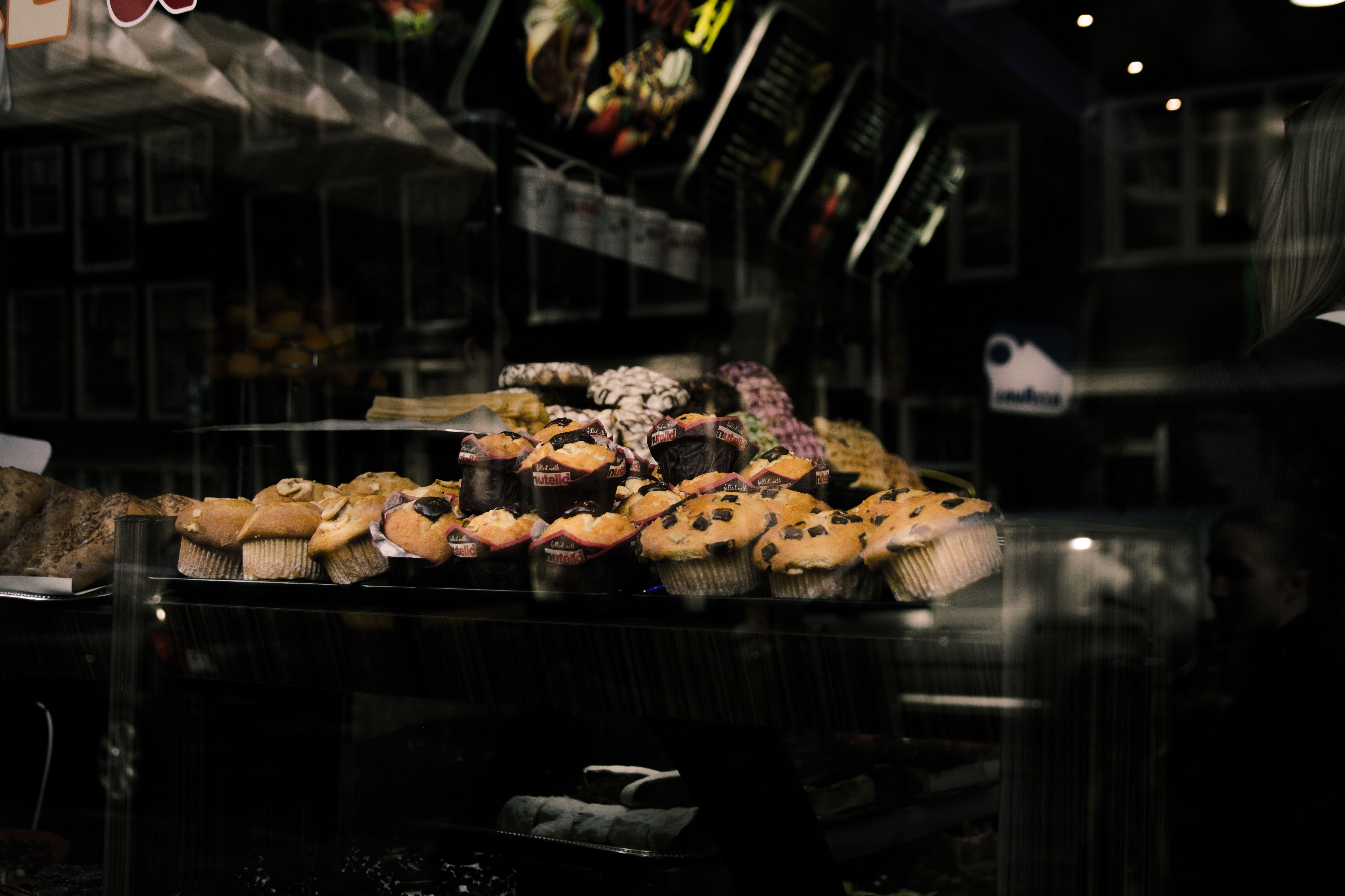 A display of assorted muffins inside a bakery in Brussels. Perfect scene for bakery enthusiasts.
