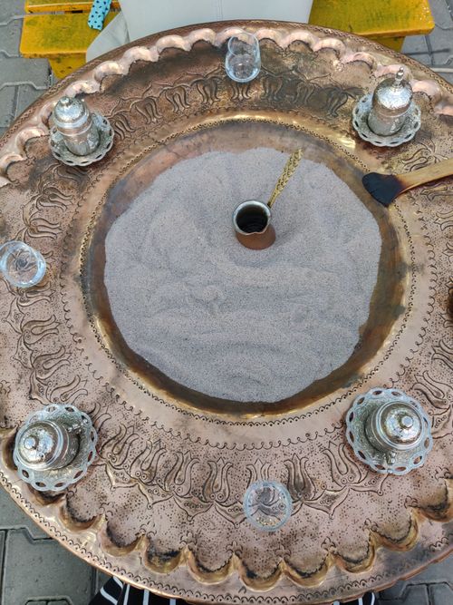Free Intricately designed brass sand coffee maker with silverware accents, ideal for brewing Turkish coffee. Stock Photo
