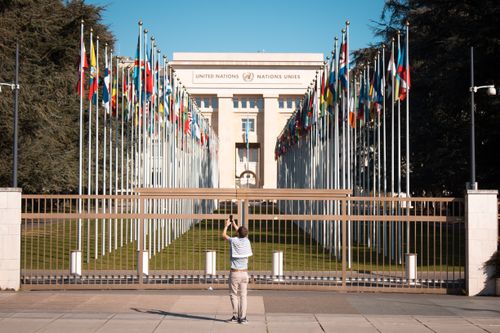 Free Man photographs the United Nations Office with international flags in Geneva, Switzerland. Stock Photo