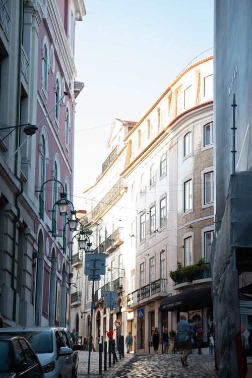 Free A picturesque alley in Lisbon showcasing historic architecture and urban charm. Stock Photo