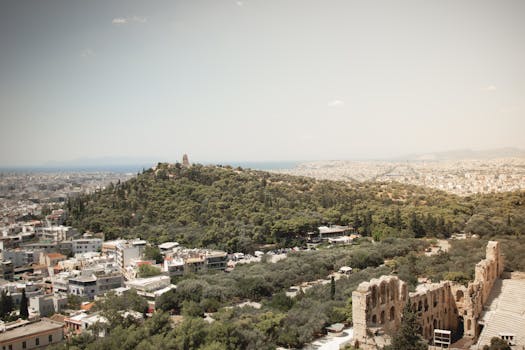 A stunning view of Athens showcasing ancient ruins and lush greenery from a high vantage point.