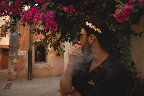 Man in Black Shirt Smoking a Cigarette