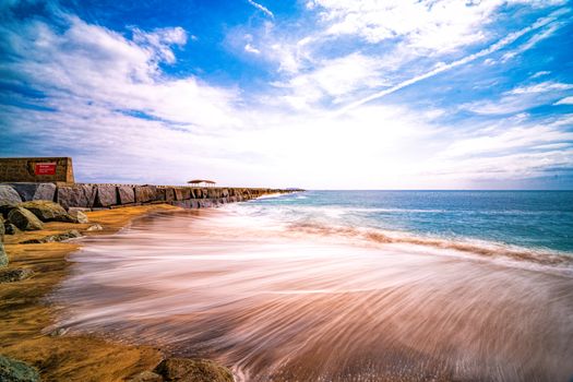 Serene long exposure capturing the vibrant coastal scene in Los Angeles.