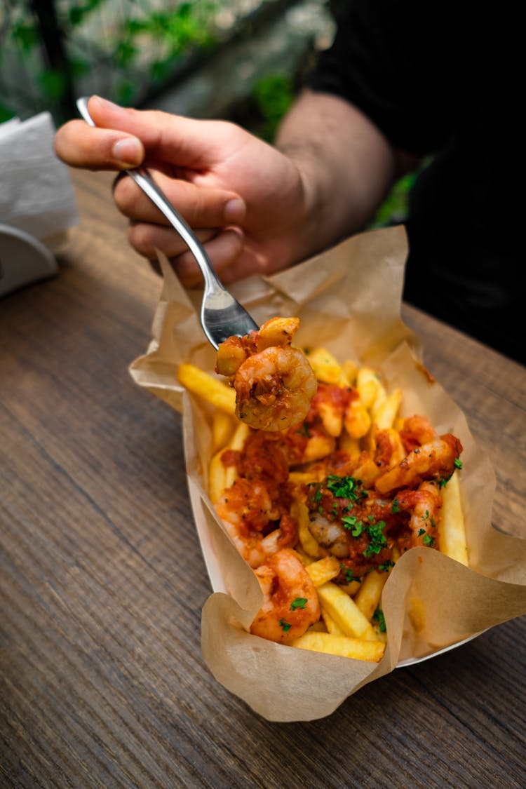 A Person Eating With Stainless Fork