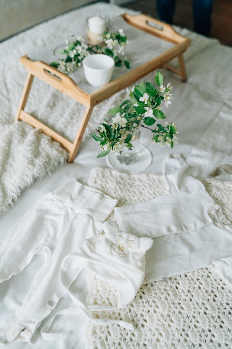 Photo Of Baby Clothes Near Flowers