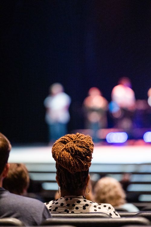Free A diverse audience attentively watching a live stage performance. Stock Photo