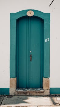 Vintage green door with number 187 on a colonial building in Tiradentes, Brazil.