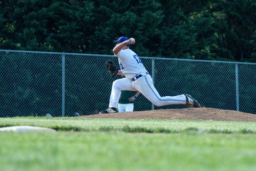 Youth pitcher mid-throw on the mound