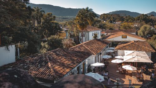 Free Scenic aerial shot of Tiradentes, Brazil, showcasing an outdoor restaurant and mountain backdrop. Stock Photo