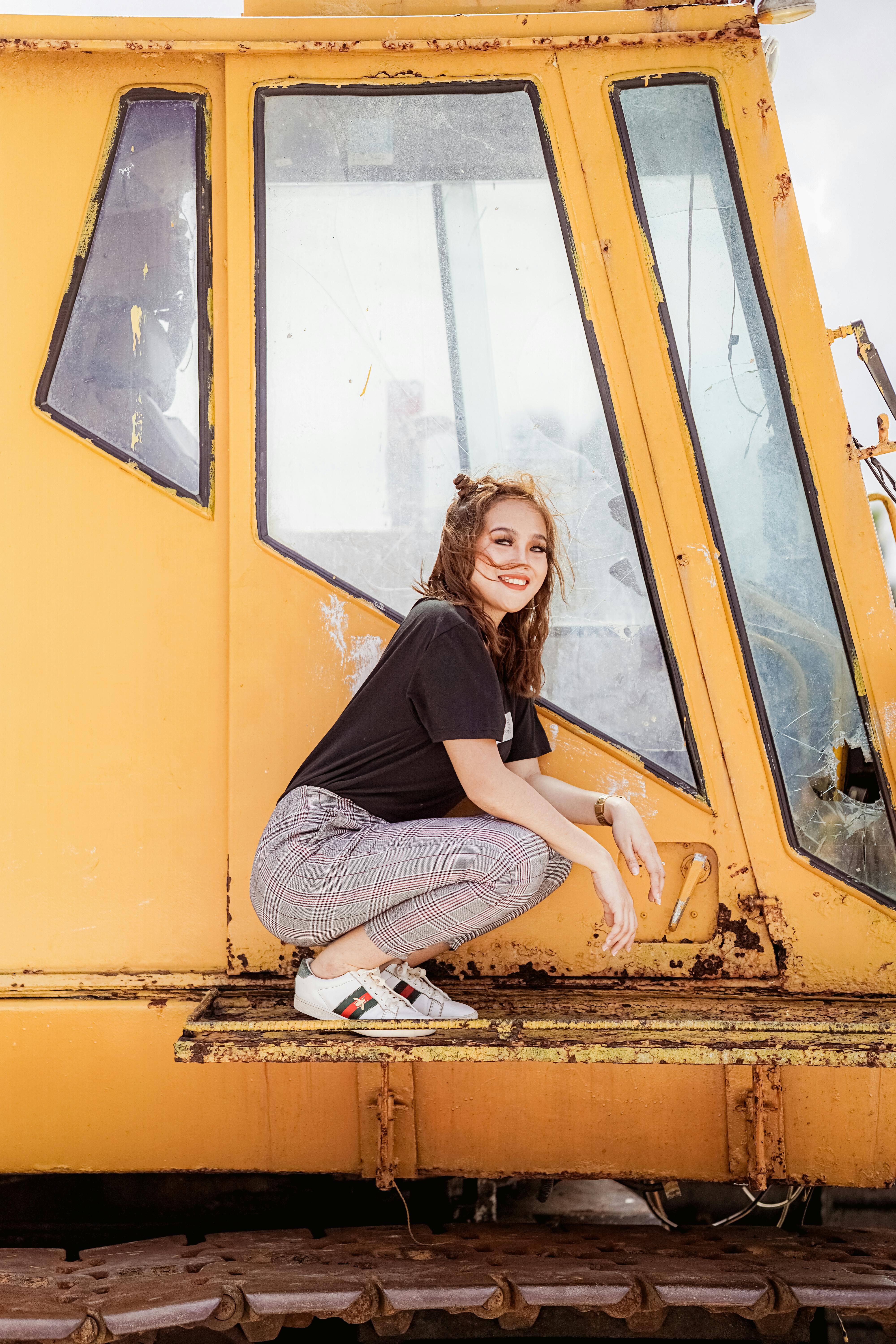 woman sitting next to abandoned train