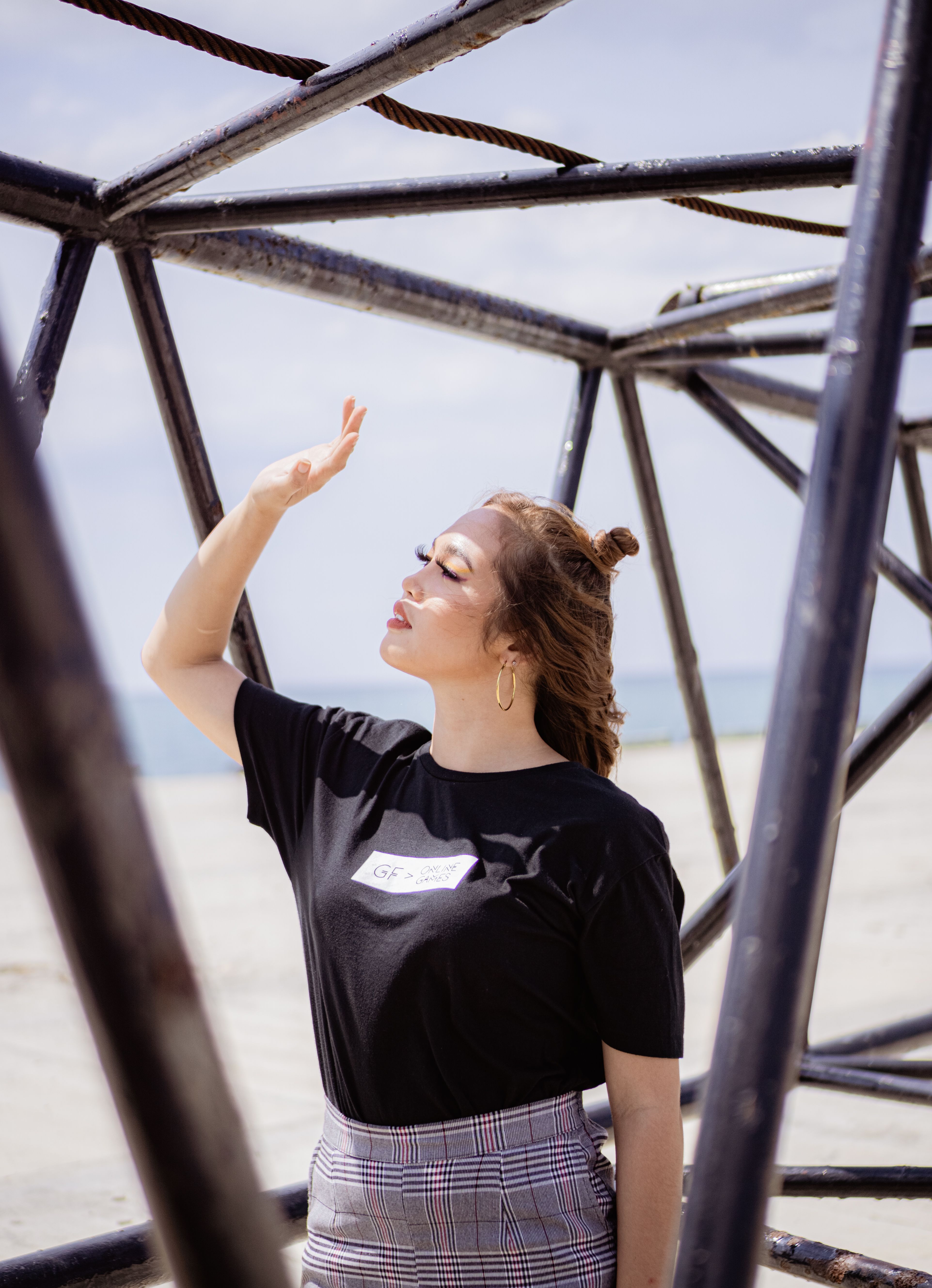 Woman at beach shielding eyes from sun, feeling free and brave