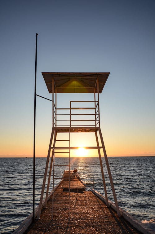 Free A Lifeguard Station Near the Sea During Sunset Stock Photo