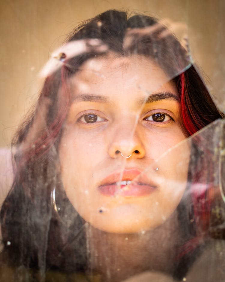 Portrait Of A Young Woman Behind A Broken Window 