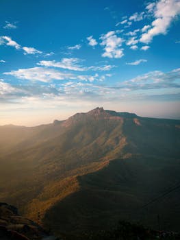 A breathtaking view of the Girnar hills at sunrise showcasing natural beauty and vast landscapes.