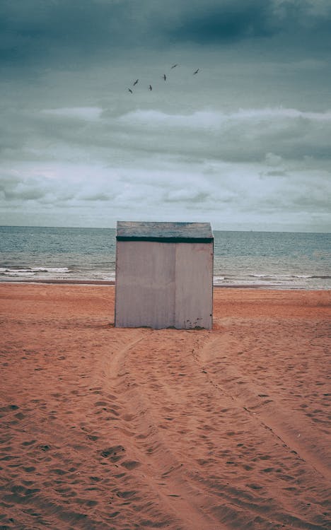 Free Gray Storage Shed on Brown Sand Stock Photo