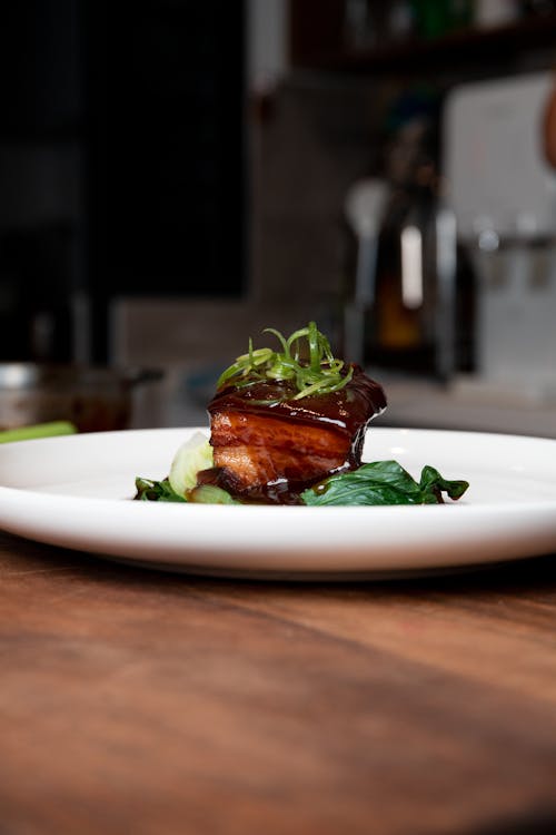 Cooked Meat With Green Vegetable on White Ceramic Plate