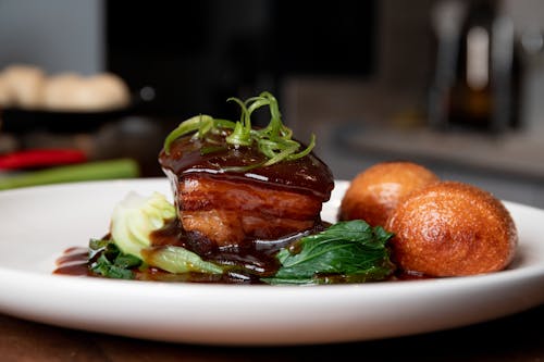 Close-Up Shot of Cooked Food on White Ceramic Plate