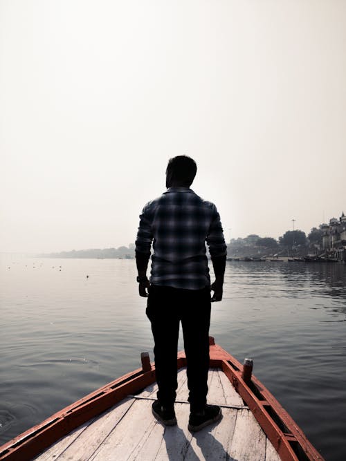Free Man Standing On Wooden Boat Stock Photo