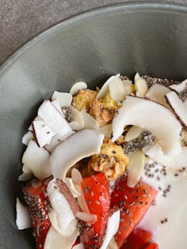 Colorful breakfast bowl with fruits, coconut, and seeds for a healthy start.
