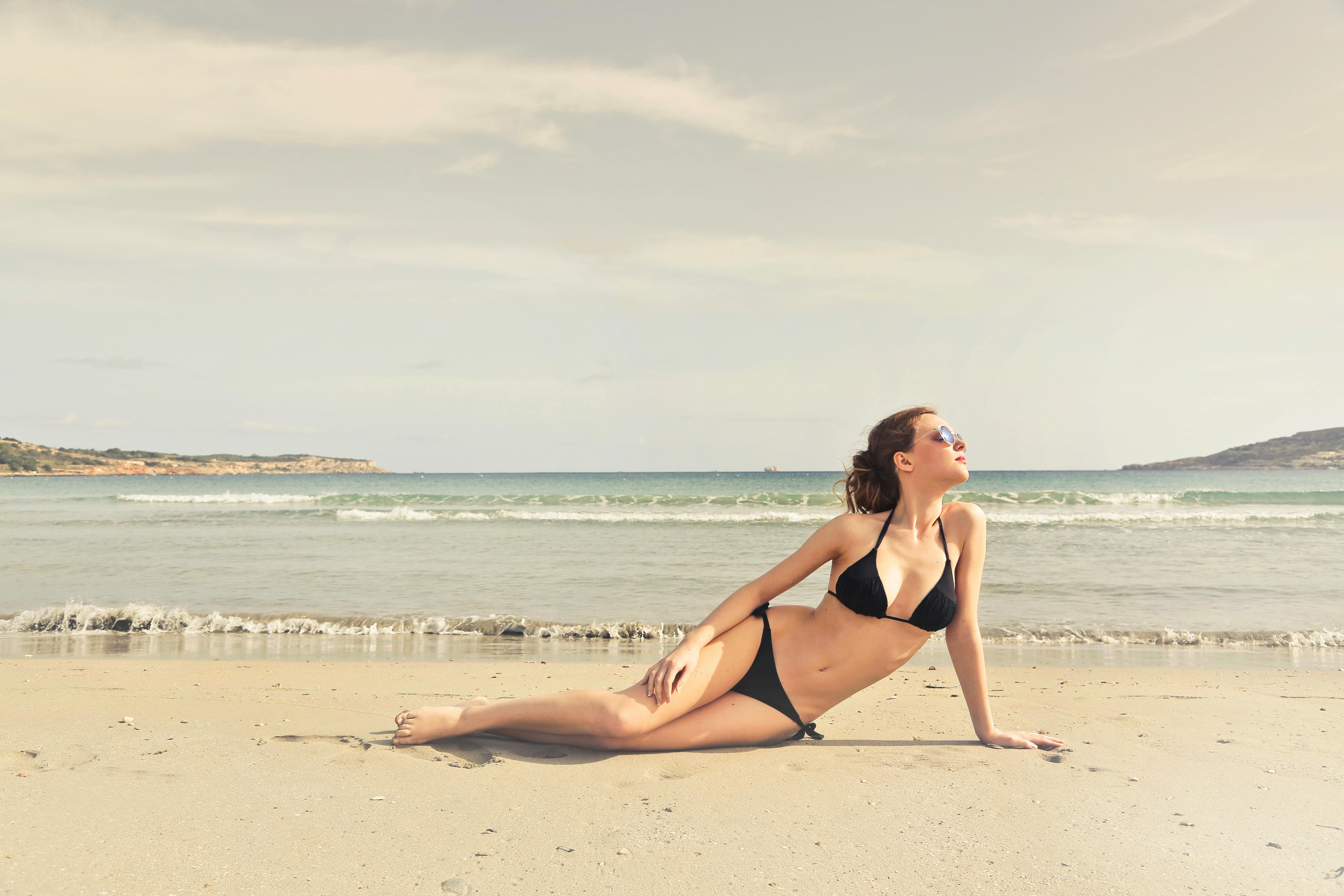 woman in black bikini on seashore