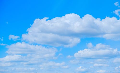 Free Bright and vivid sky filled with puffy white cumulus clouds on a sunny day. Stock Photo