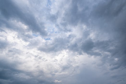 A scenic view of the dramatic cloudy sky with fluffy, puffy clouds.