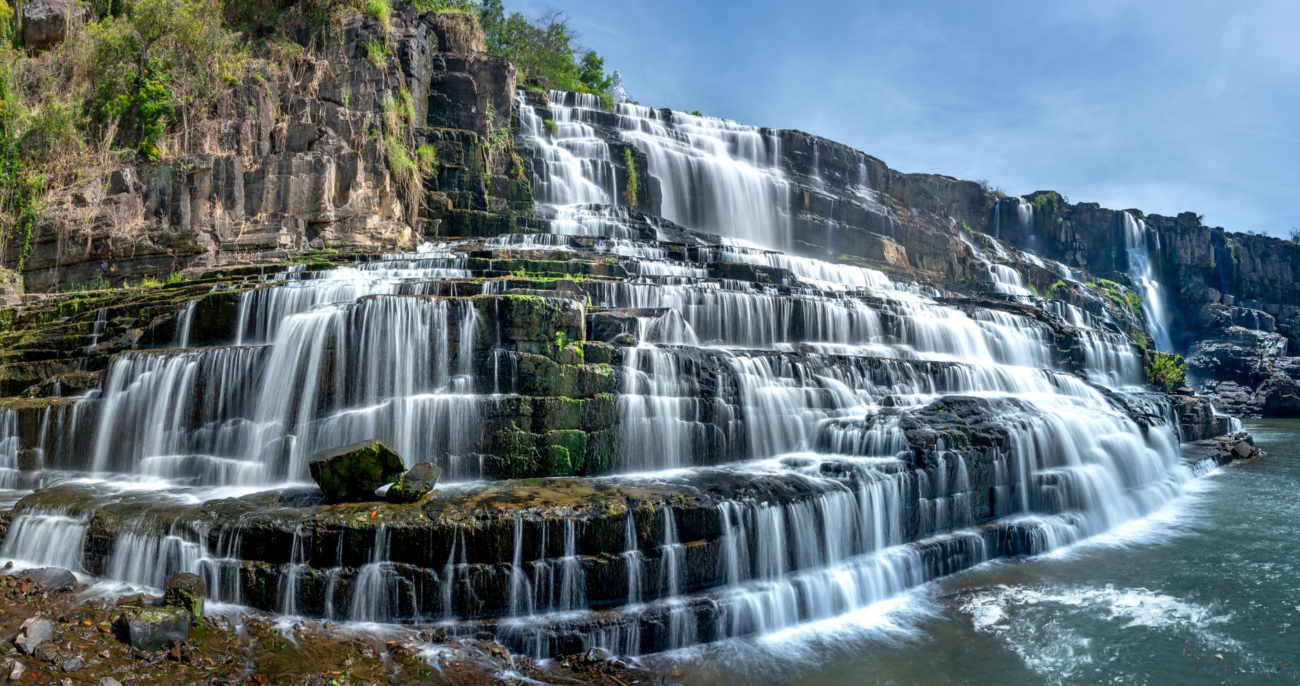 Panoramic view of the tiered and majestic Pongour Waterfall in Vietnam.