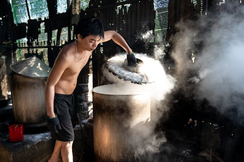 Man Working with Steaming Hot Container