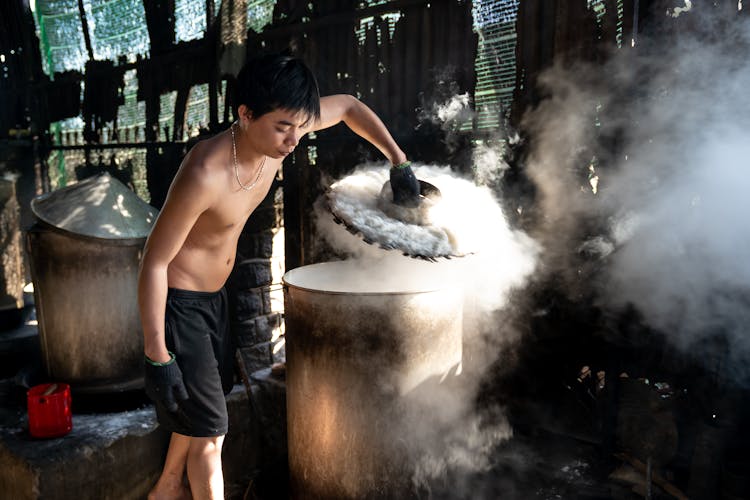 Man Working With Steaming Hot Container