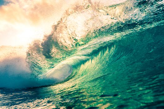 Amazing scenery of azure splashing waves rolling on rippling sea surface beneath light pink sunny sky