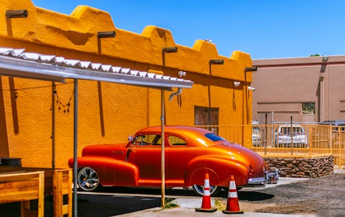 Free Chevrolet Coupe Car Parked Beside Brown Concrete Building Stock Photo